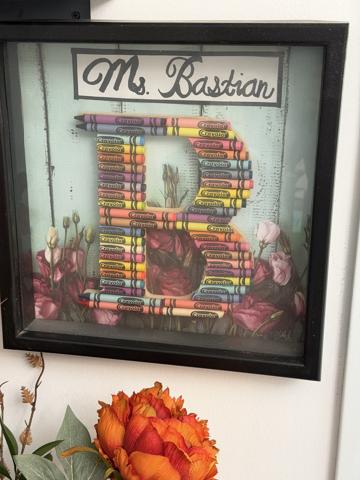 framed crayon letter B labeled Ms. Bastian.